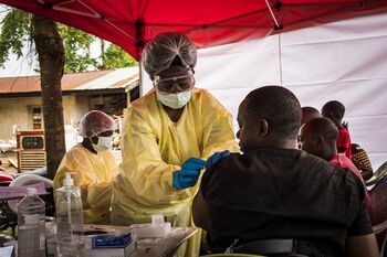 Beni, North Kivu region, DRC.Health worker vaccinates individual who was near an Ebola affected person